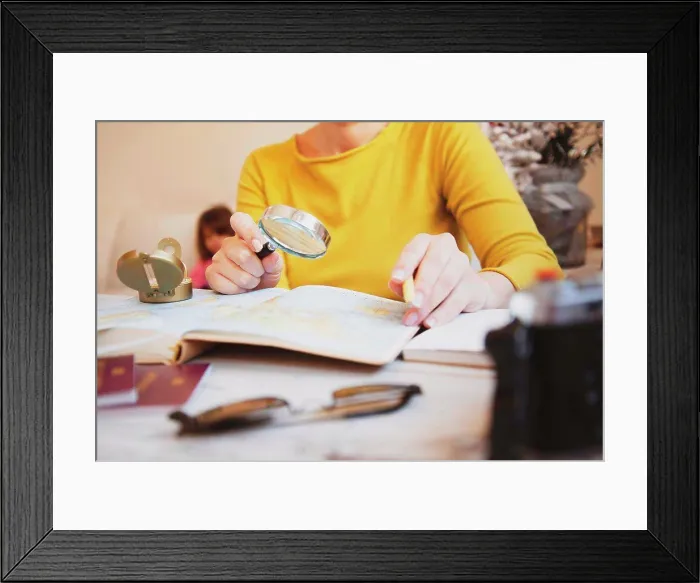 Framed Print : Woman planning tour with travel map at home - Mum looking for new countries to explore with her family - Concept of