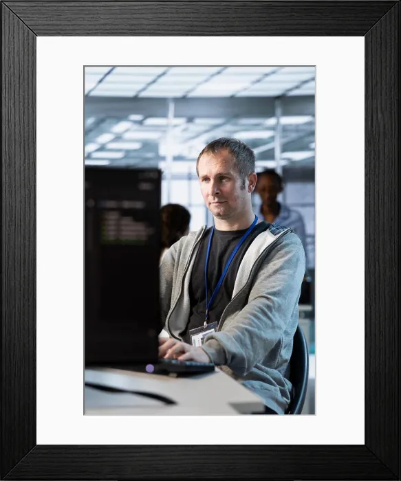 Framed Print : IT professional optimizing data center gear for maximum efficiency and uptime Framed Print : IT professional optimizing data center gear for maximum efficiency and uptime
