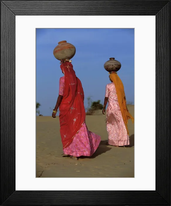 Framed Print : Bhil indigenous women carrying water jugs on their heads, Rajasthan Desert, India