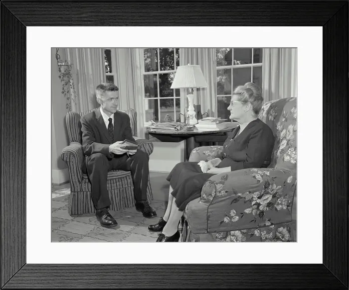 Framed Print : Vintage Photograph. Minister talking to woman in her home. Frame 1 Framed Print : Vintage Photograph. Minister talking to woman in her home. Frame 1