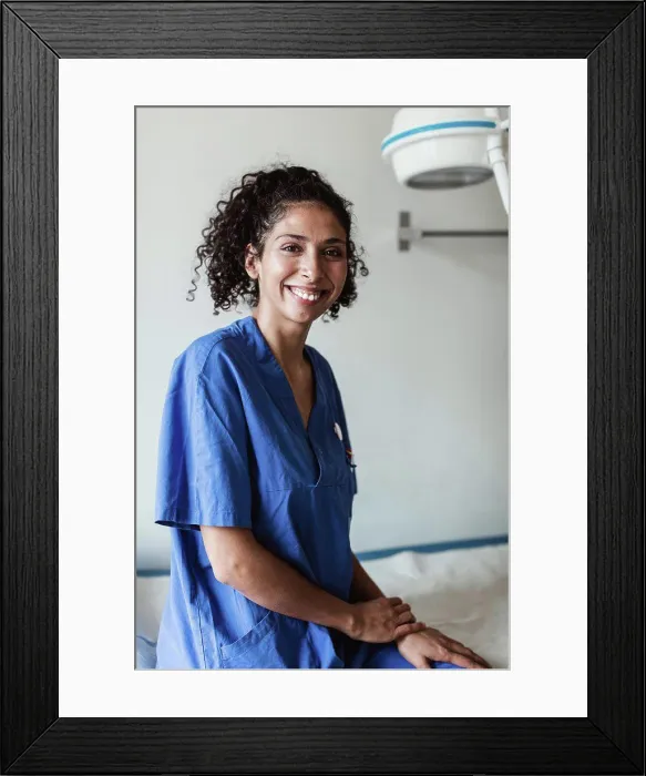 Framed Print : Portrait of confident female doctor sitting in medical clinic Framed Print : Portrait of confident female doctor sitting in medical clinic