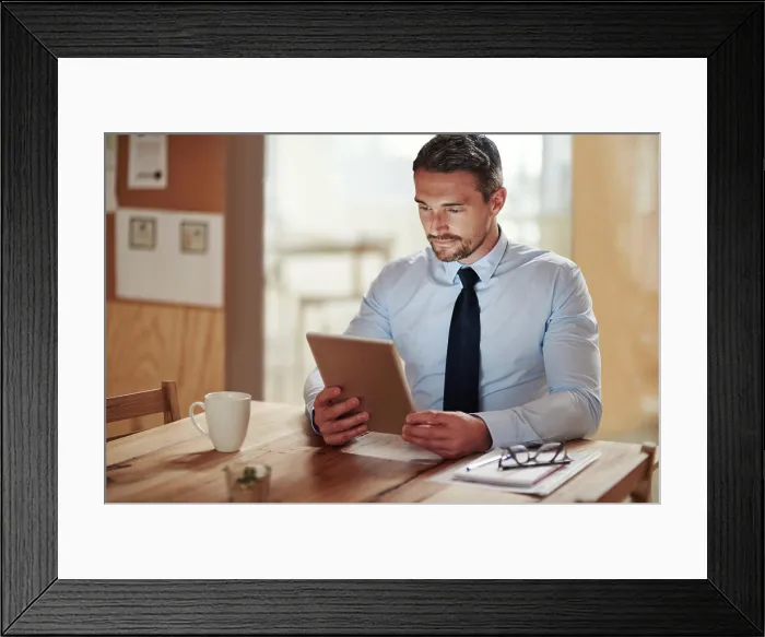 Framed Print : Tablet, reading and businessman in office with email for online CV review for recruitment Framed Print : Tablet, reading and businessman in office with email for online CV review for recruitment
