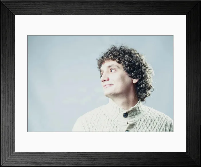 Framed Print : Detailed portrait of a young guy with curly hair Looking away Framed Print : Detailed portrait of a young guy with curly hair Looking away