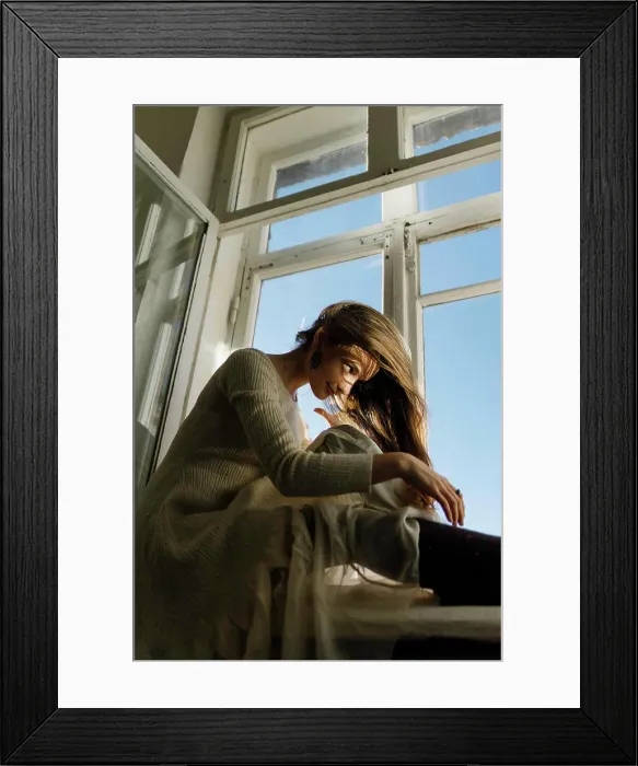 Framed Print : woman sitting on the windowsill in a dress Framed Print : woman sitting on the windowsill in a dress