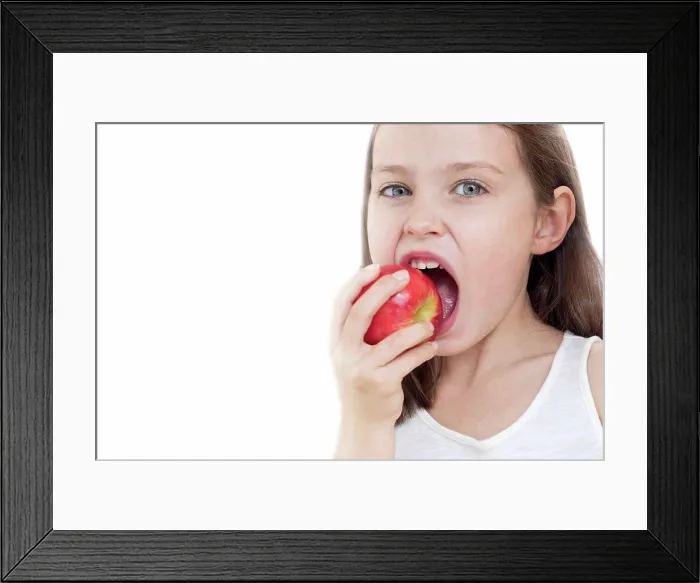 Framed Print : Girl biting apple Framed Print : Girl biting apple
