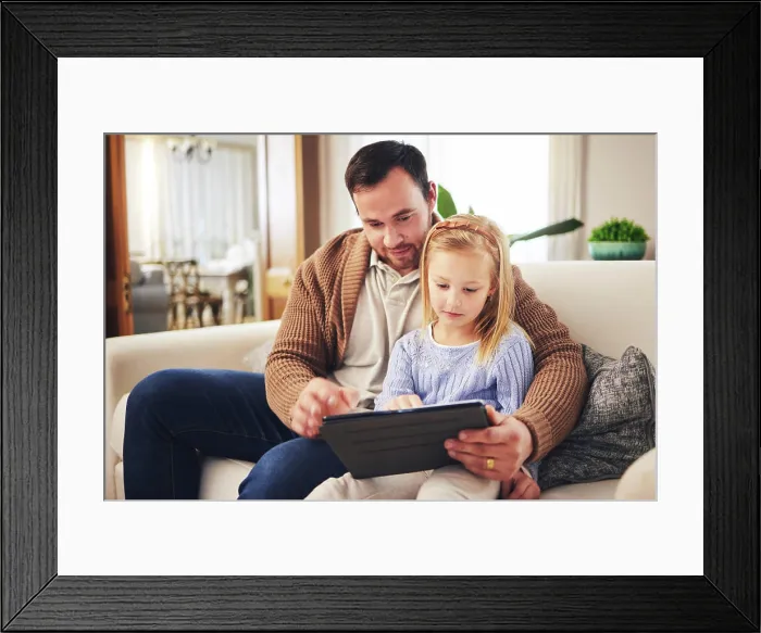 Framed Print : Child, dad and a tablet for learning in a family home while reading or playing a game for education Framed Print : Child, dad and a tablet for learning in a family home while reading or playing a game for education