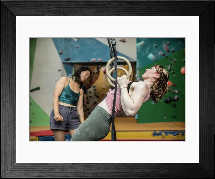 Framed Print : Young woman exercising at gymnastics rings in climbing center Framed Print : Young woman exercising at gymnastics rings in climbing center