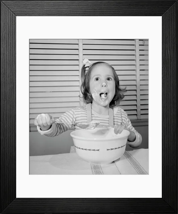 Framed Print : Close-up of a girl eating with a large spoon