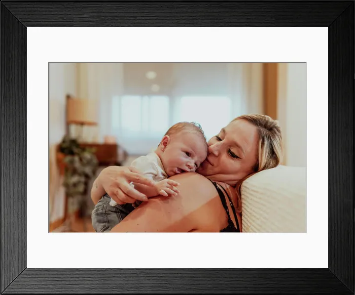 Framed Print : Happy mother looking at baby boy while sitting at home Framed Print : Happy mother looking at baby boy while sitting at home