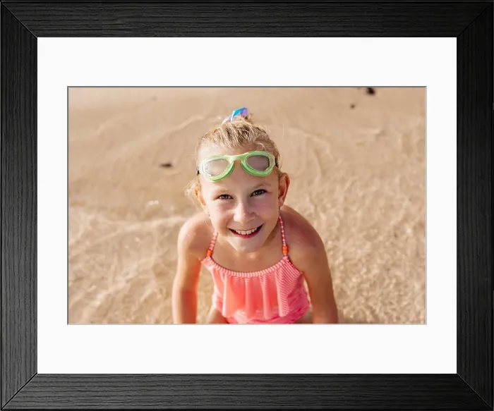 Framed Print : Young girl playing, swiming and splashing in fresh sea water