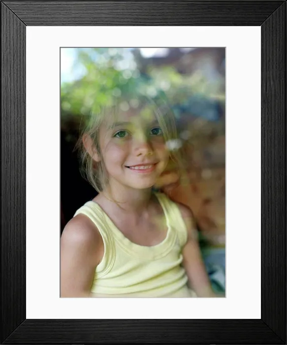 Framed Print : Girl playing in a Wendy house Framed Print : Girl playing in a Wendy house