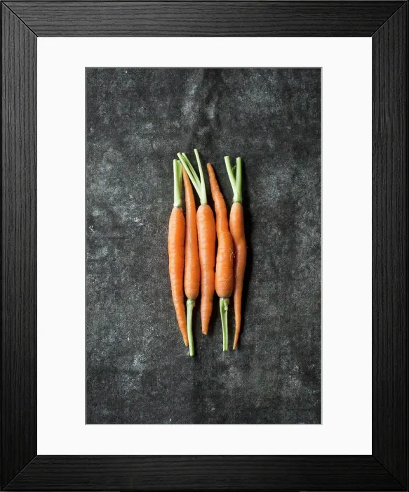 Framed Print : Five baby carrots next to each other on a grey surface