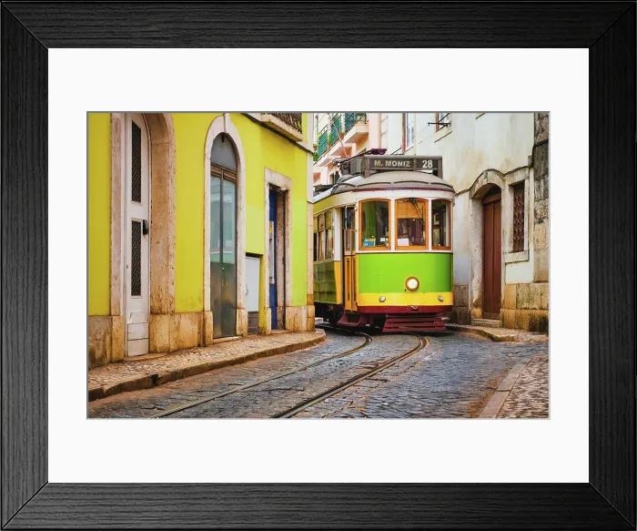 Framed Print : Famous vintage yellow tram 28 in the narrow streets of Alfama district in Lisbon