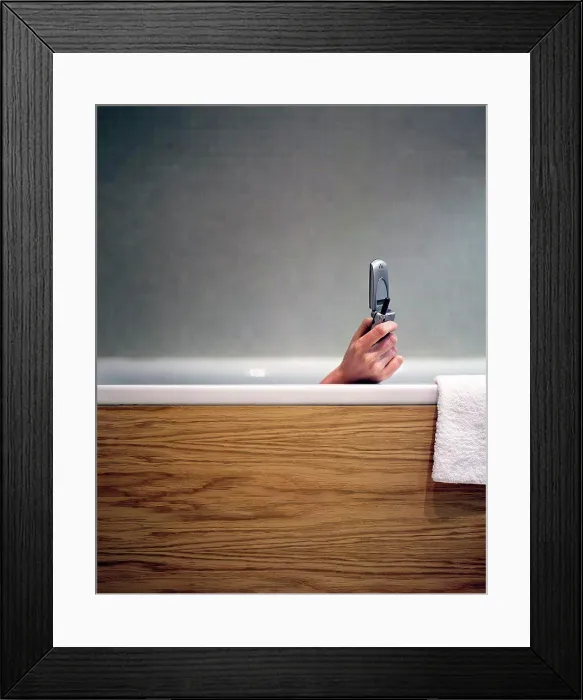 Framed Print : Woman text messaging in bath