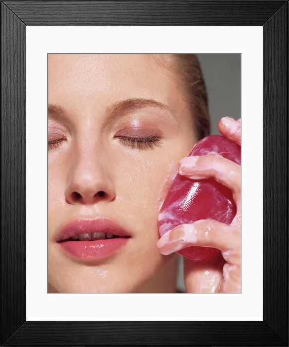 Framed Print : Woman cleansing her face with soap