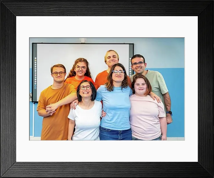 Framed Print : Frontal formal portrait of a disabled yoga class members standing smiling at camera