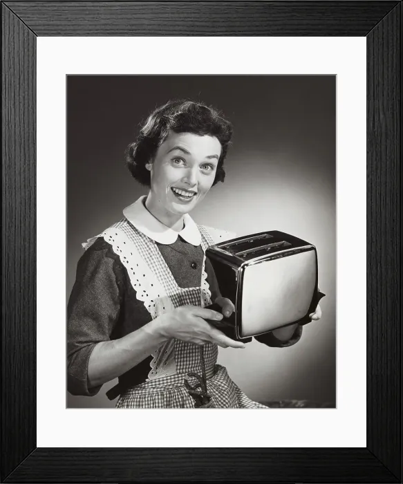 Framed Print : Studio shot of woman holding toaster Framed Print : Studio shot of woman holding toaster