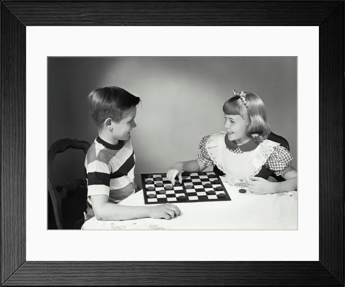 Framed Print : Vintage photograph. Children at table playing checkers Framed Print : Vintage photograph. Children at table playing checkers
