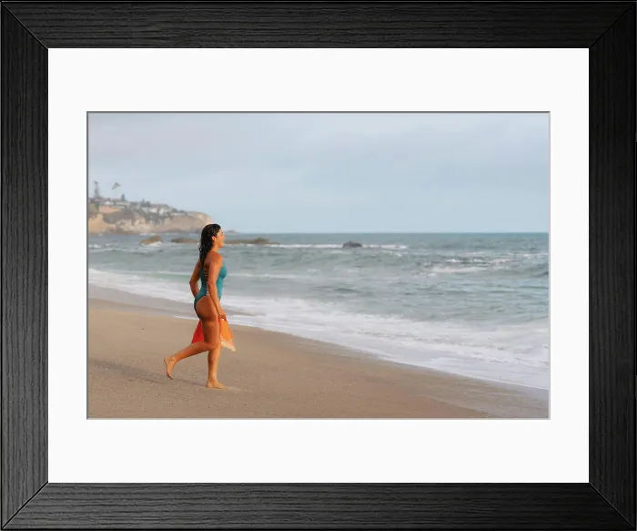 Framed Print : Woman holding swim fins running into water Framed Print : Woman holding swim fins running into water