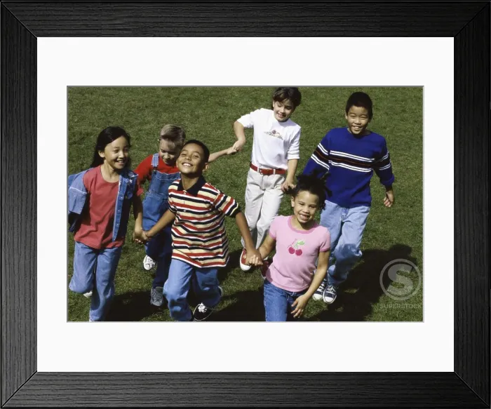 Framed Print : Portrait of a group of children running together holding hands Framed Print : Portrait of a group of children running together holding hands