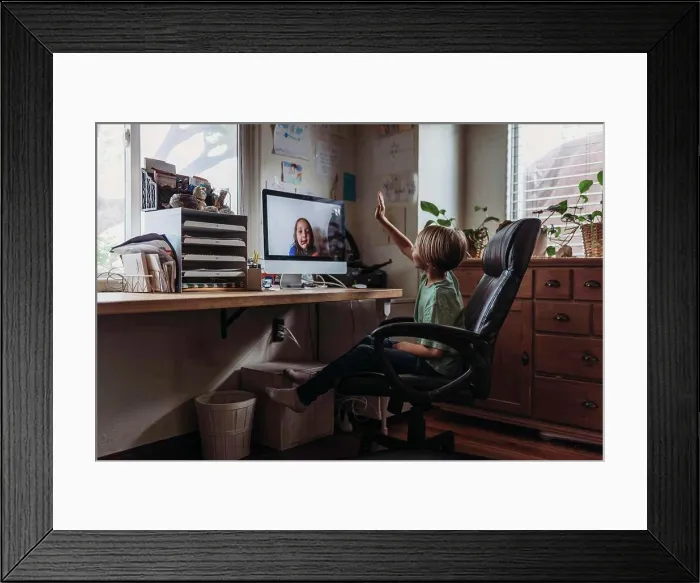 Framed Print : Young boy video chatting with family remotely during isolation Framed Print : Young boy video chatting with family remotely during isolation
