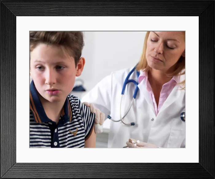 Framed Print : Doctor injecting 10 year old boy a drug in a clinic Framed Print : Doctor injecting 10 year old boy a drug in a clinic