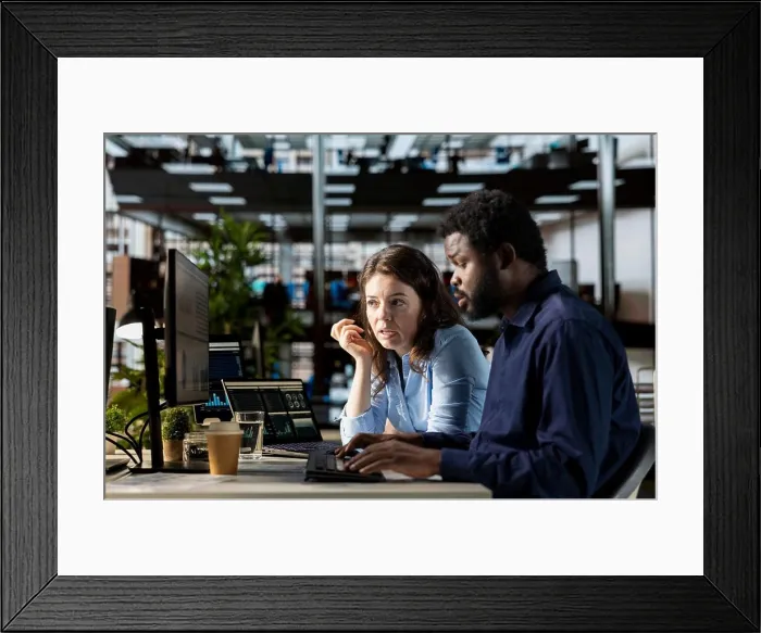 Framed Print : Diverse staff in the office engaged in infographics analysis for problem solving tasks Framed Print : Diverse staff in the office engaged in infographics analysis for problem solving tasks