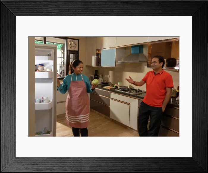 Framed Print : Indian woman talking to her husband in the kitchen Framed Print : Indian woman talking to her husband in the kitchen