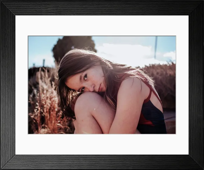 Framed Print : Teen girl in a swimsuit sitting outside on a sunny day Framed Print : Teen girl in a swimsuit sitting outside on a sunny day