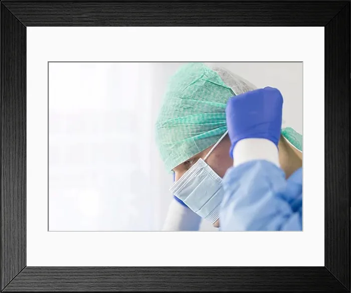 Framed Print : Surgeon doctor in sterile gloves preparing for operation in hospital. He is wearing surgical cap and blue gown Framed Print : Surgeon doctor in sterile gloves preparing for operation in hospital. He is wearing surgical cap and blue gown