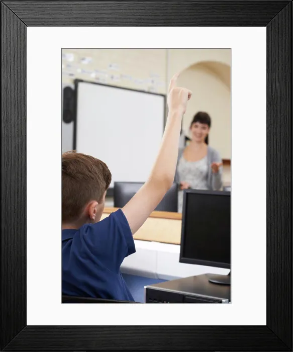 Framed Print : Male Pupil Answering Question In School Classroom Framed Print : Male Pupil Answering Question In School Classroom