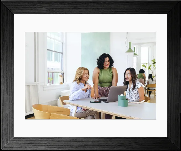 Framed Print : Smiling multiracial colleagues during meeting in creative office Framed Print : Smiling multiracial colleagues during meeting in creative office