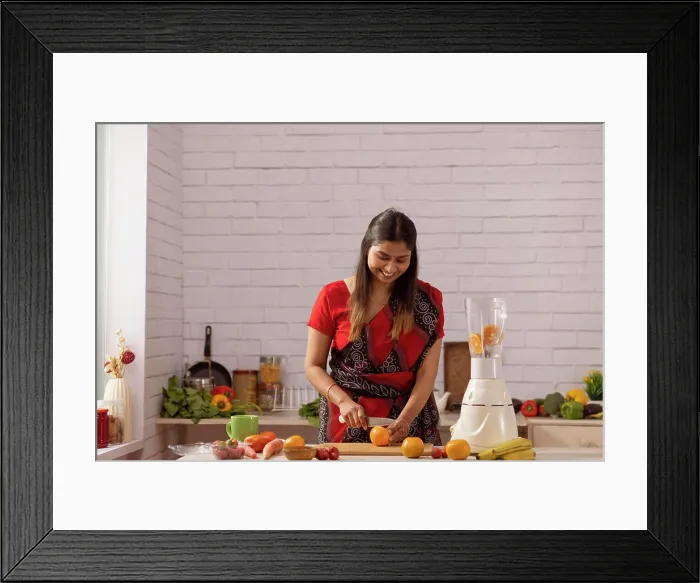 Framed Print : Portrait of cheerful woman chopping fresh fruit in kitchen Framed Print : Portrait of cheerful woman chopping fresh fruit in kitchen