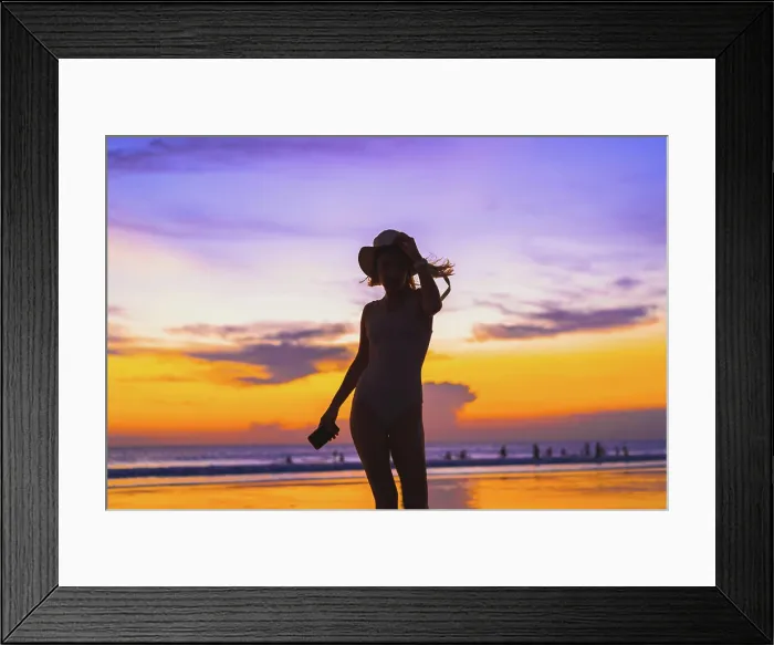 Framed Print : Woman in a panama hat on the ocean beach. Sunset in Bali