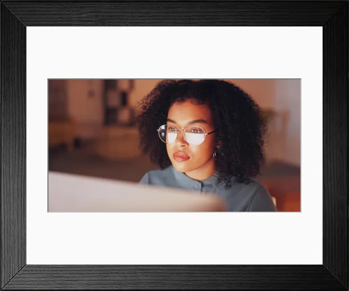 Framed Print : Glasses, computer and woman in office at night working on creative project with deadline Framed Print : Glasses, computer and woman in office at night working on creative project with deadline