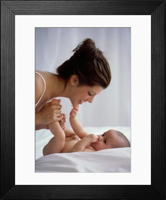 Framed Print : Side profile of a mother playing with her baby boy Framed Print : Side profile of a mother playing with her baby boy