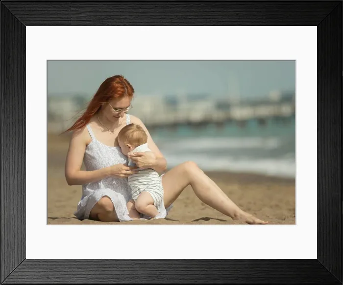 Framed Print : Mother and her little son resting on the seaside