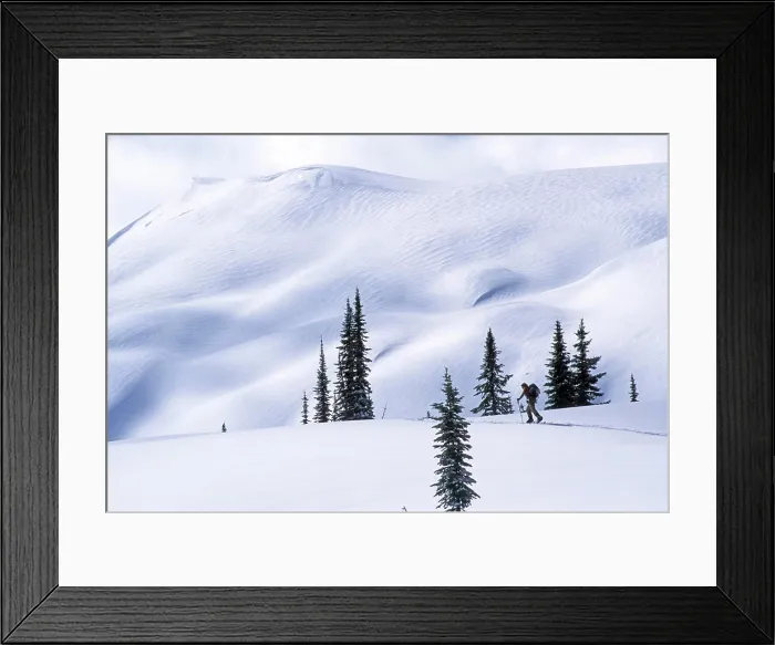 Framed Print : Two backcountry skiers ascending (skinning) up among large peaks Framed Print : Two backcountry skiers ascending (skinning) up among large peaks