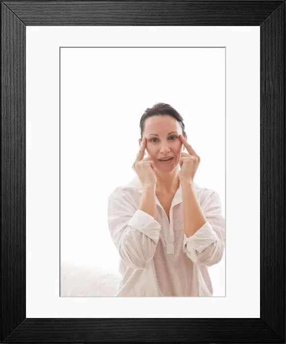 Framed Print : woman massaging face Framed Print : woman massaging face