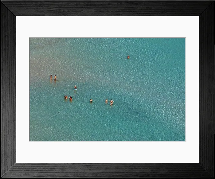 Framed Print : Green lagoon, single people standing in shallow water