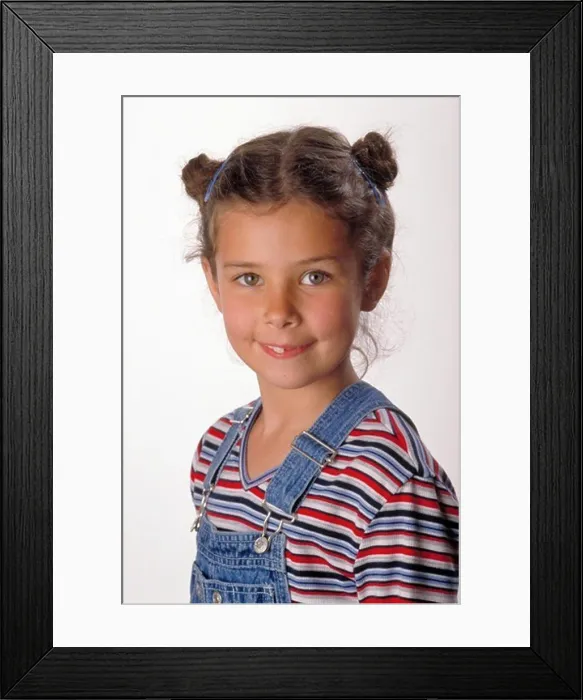 Framed Print : Portrait of Smiling Young Girl in Overalls Framed Print : Portrait of Smiling Young Girl in Overalls