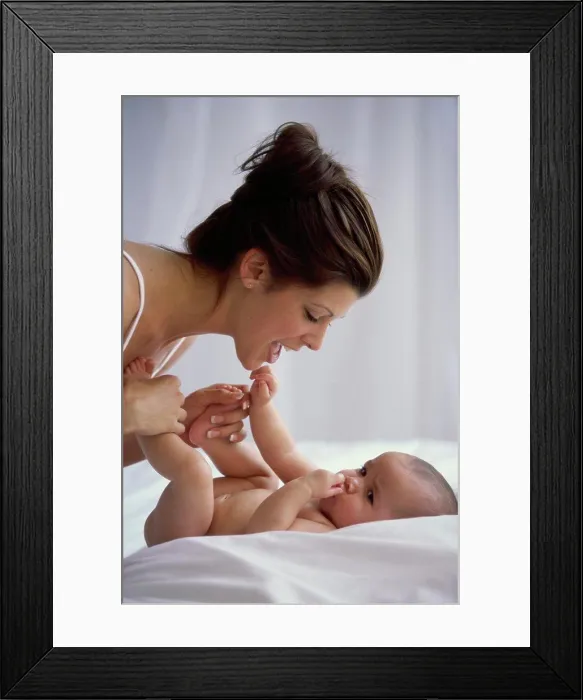 Framed Print : Side profile of a mother playing with her baby boy Framed Print : Side profile of a mother playing with her baby boy