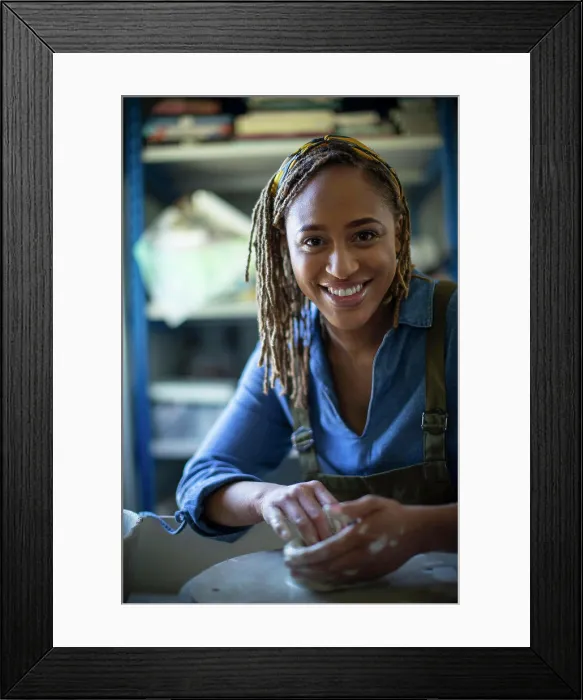 Framed Print : Portrait happy young female artist at pottery wheel