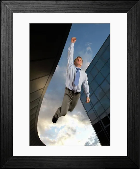 Framed Print : Businessman flying overtop of the city Framed Print : Businessman flying overtop of the city