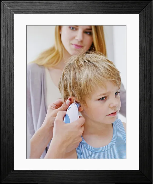 Framed Print : Doctor measuring a child's temperature Framed Print : Doctor measuring a child's temperature