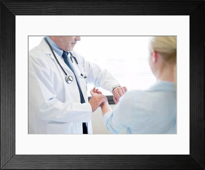 Framed Print : Male doctor taking patient's pulse Framed Print : Male doctor taking patient's pulse