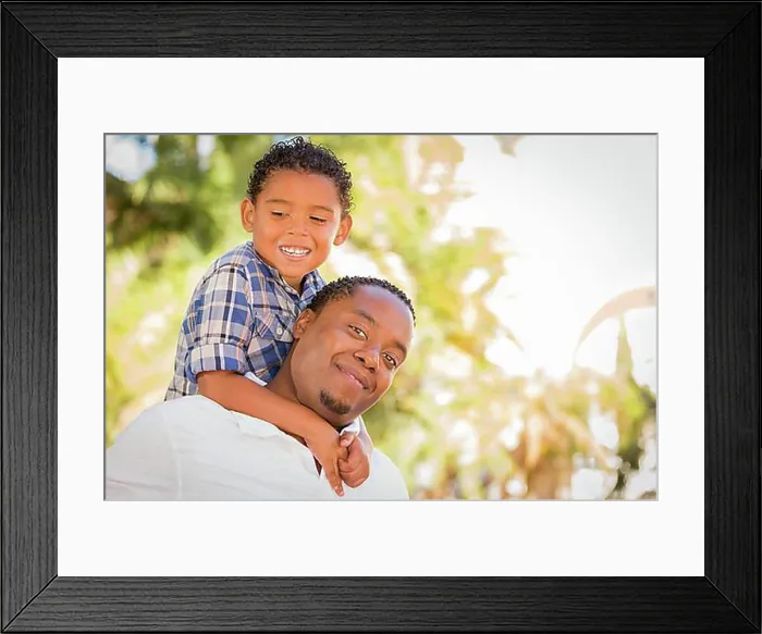 Framed Print : Happy african american father and mixed-race son playing piggyback in the park Framed Print : Happy african american father and mixed-race son playing piggyback in the park