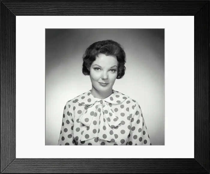 Framed Print : Vintage Photograph. Brunette woman wearing polka dot blouse looking at camera with warm expression Framed Print : Vintage Photograph. Brunette woman wearing polka dot blouse looking at camera with warm expression
