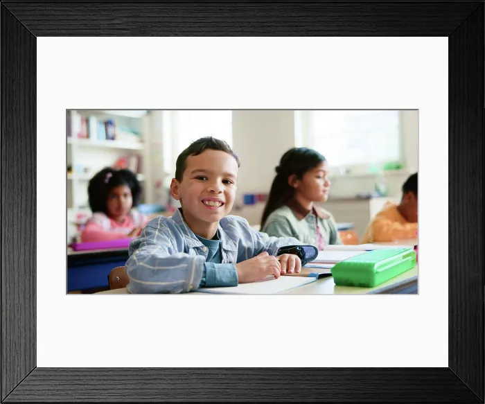 Framed Print : Smile, writing and portrait of child in classroom with confidence for education Framed Print : Smile, writing and portrait of child in classroom with confidence for education