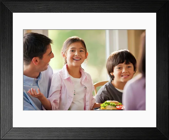 Framed Print : Happy family having fun eating at a dining table Framed Print : Happy family having fun eating at a dining table